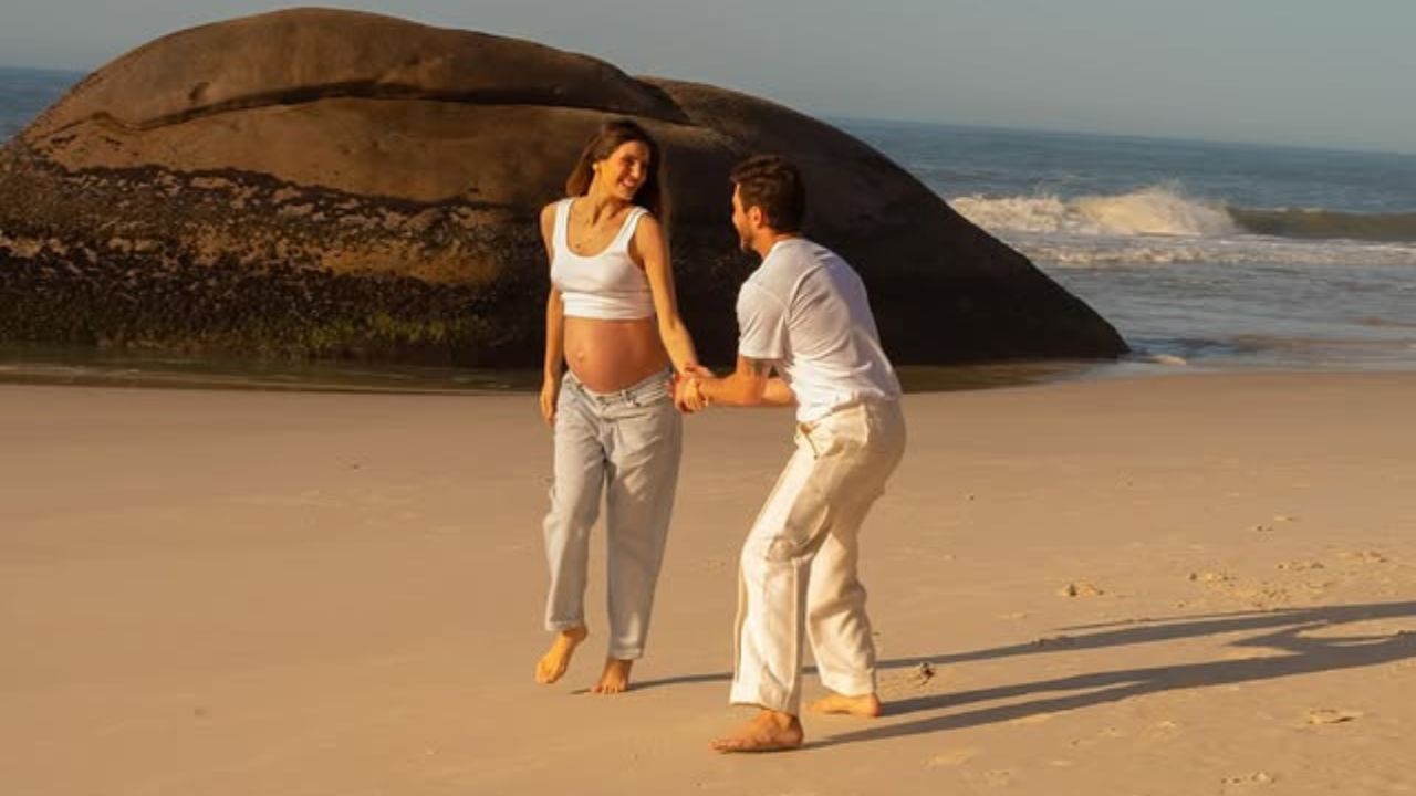 Camila Queiroz e Klebber Toledo fazem ensaio na praia à espera da primeira filha