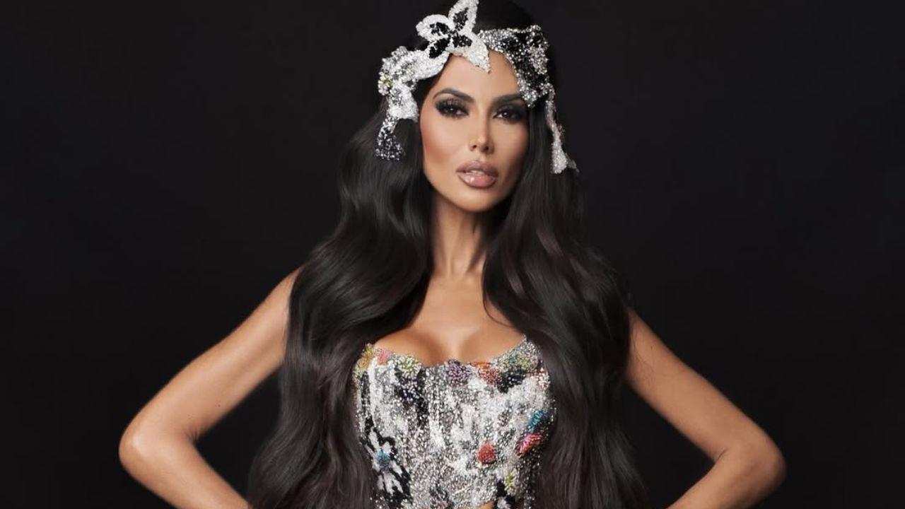 Apresentadora Flávia Noronha. Mulher branca, cabelo castanho longo, com roupa de carnaval.