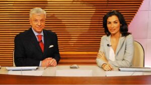 Foto de Renato Machado e Renata Vasconcellos na bancada do jornal.